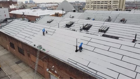 Aerial view: commercial roof crew at work
